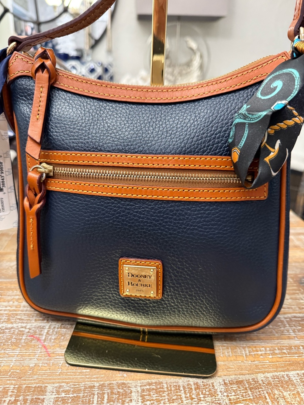 NWT Dooney & Bourke Navy with Tan Leather Trim Crossbody 9” talks 10 1/2” wide.